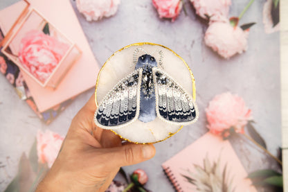 a hand holding a paper cut out of a butterfly