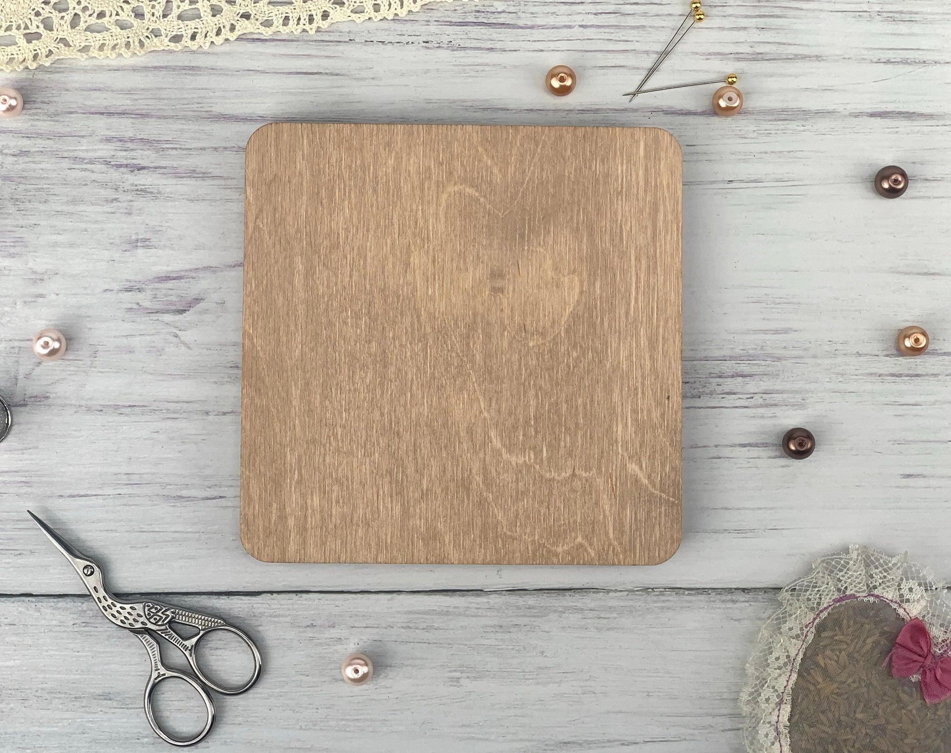 a wooden cutting board sitting on top of a white table
