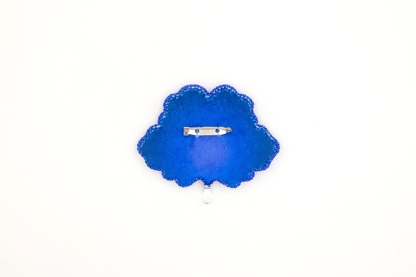 a blue brooch with a ring on it