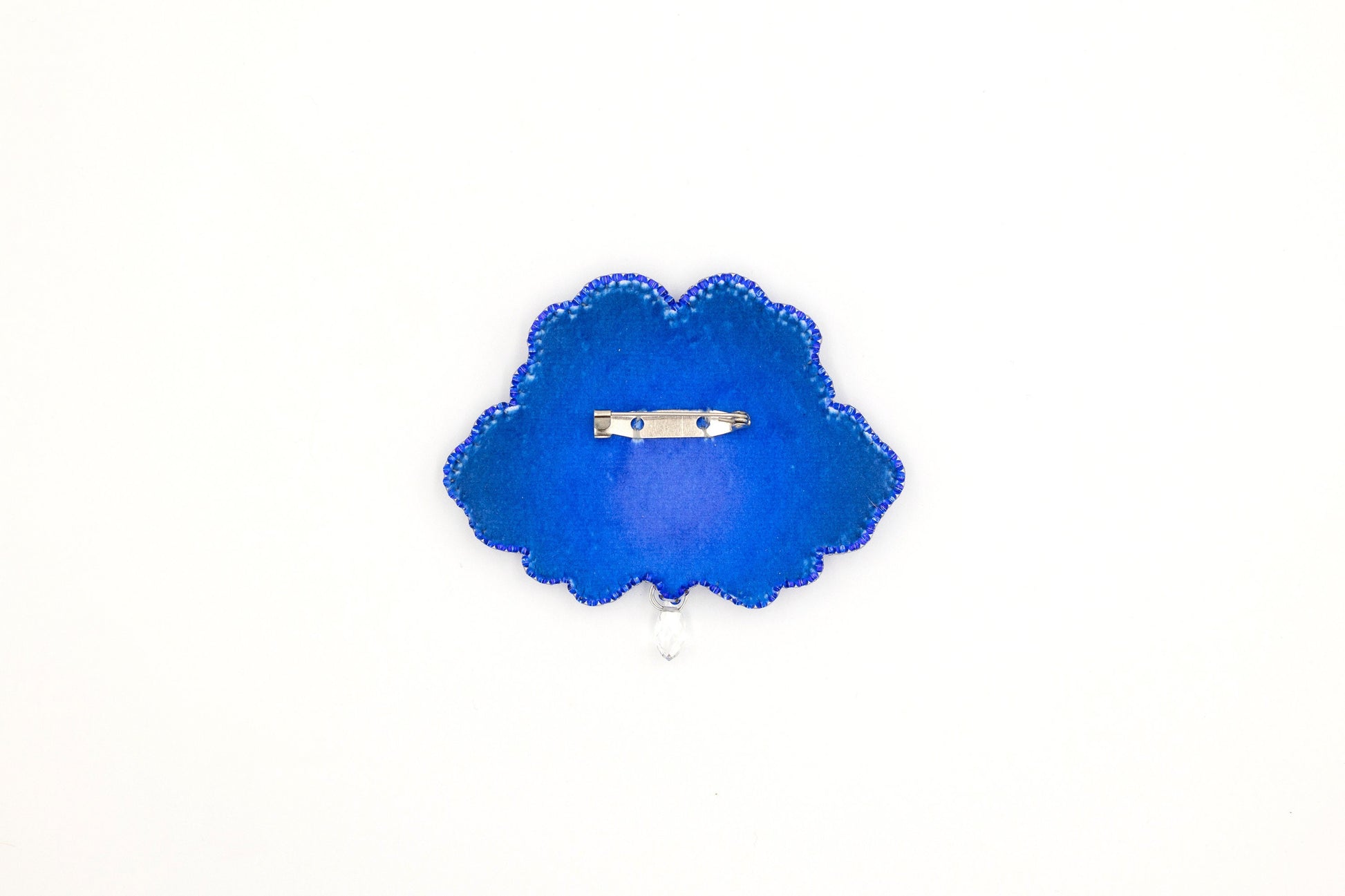 a blue brooch with a ring on it