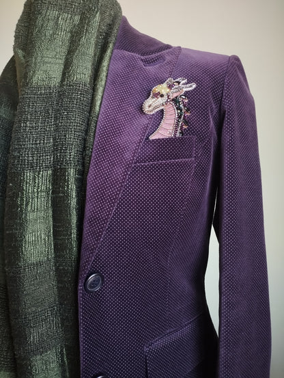 a purple jacket with a decorative dragon embroidered on the left side of the chest.
