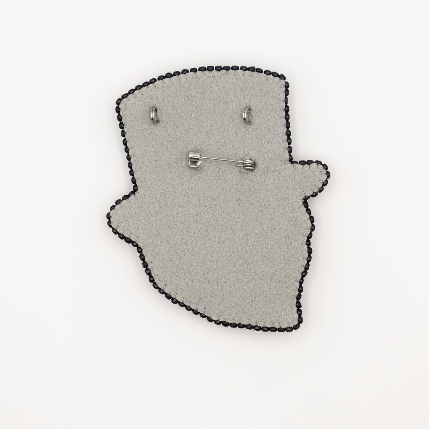 a pair of earrings sitting on top of a piece of felt