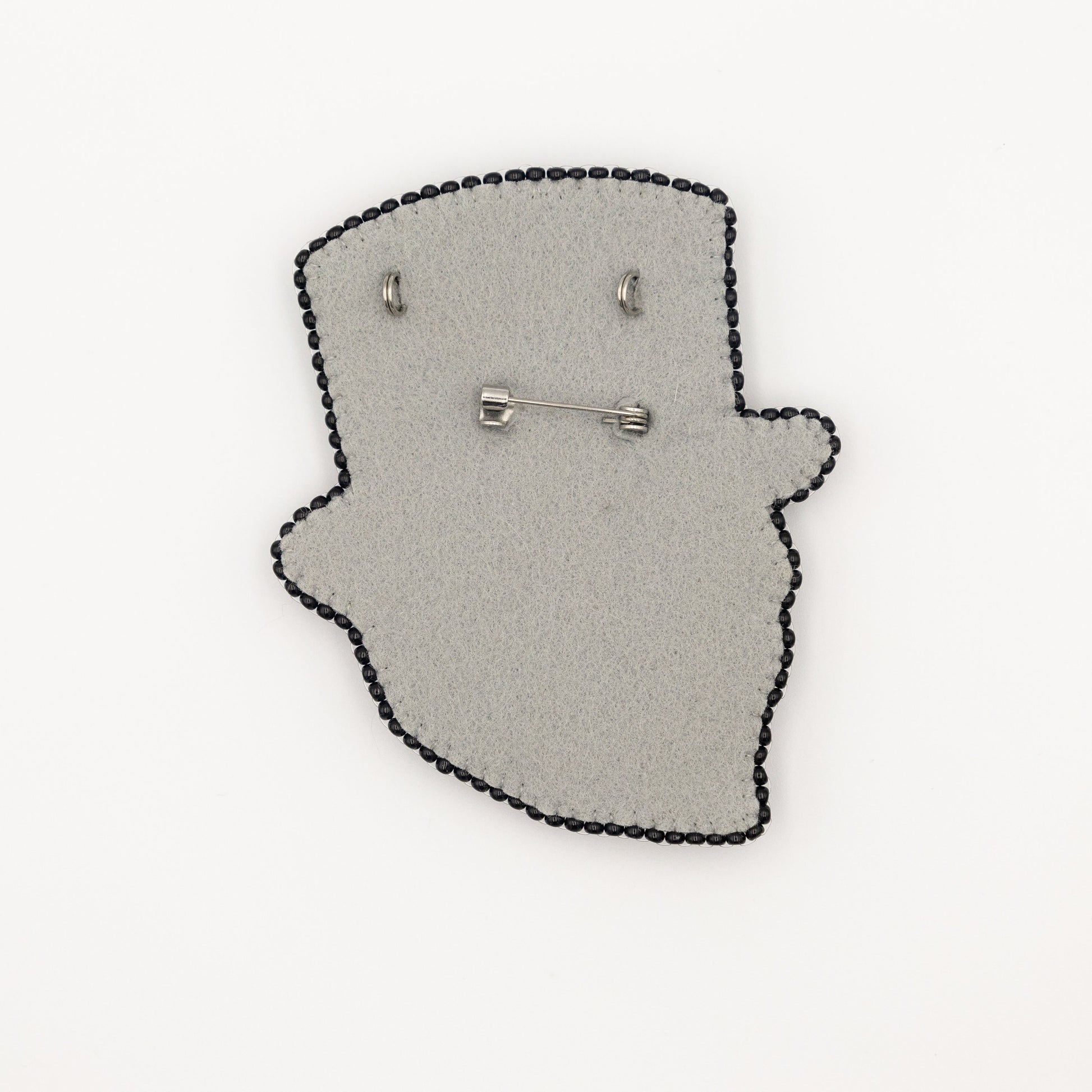 a pair of earrings sitting on top of a piece of felt