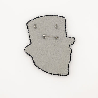 a pair of earrings sitting on top of a piece of felt