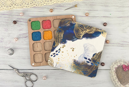 a pair of scissors next to a painting palette