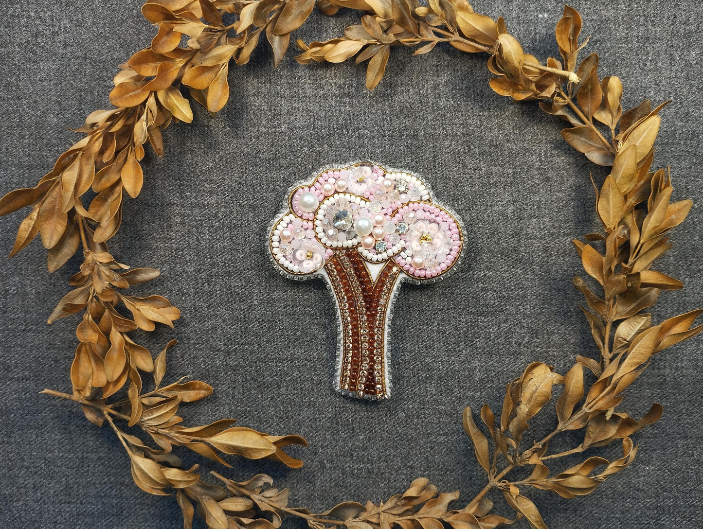 a brooch with a tree made out of beads