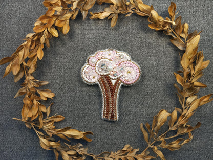 a brooch with a tree made out of beads