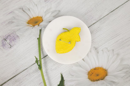 a yellow piece of fruit sitting on top of a white plate