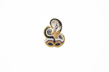 a close up of a snowman shaped object on a white surface