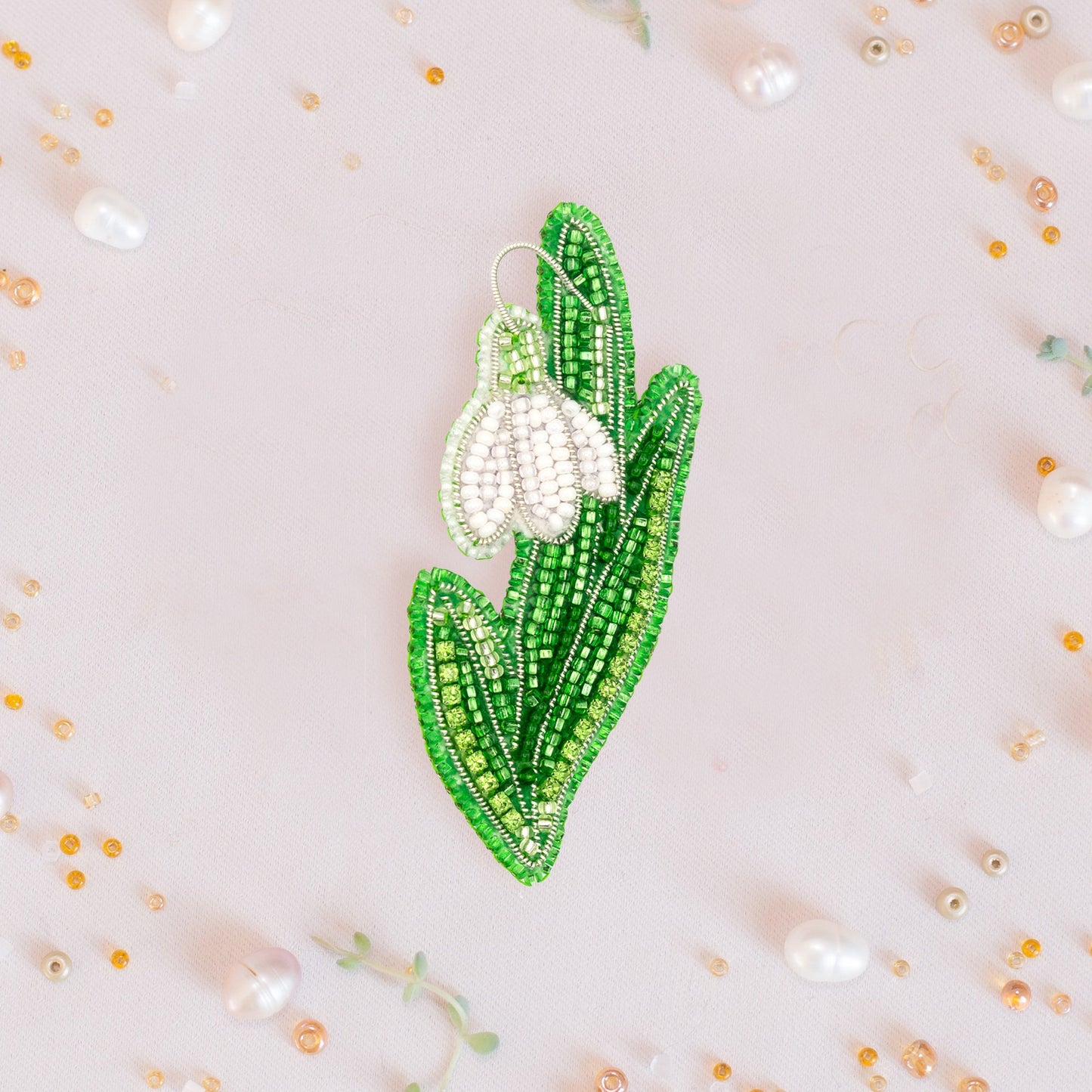 a brooch with a flower on it on a white background