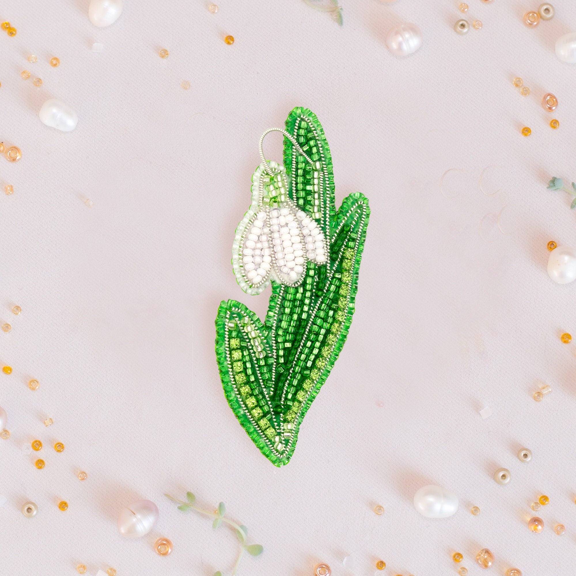 a brooch with a flower on it on a white background
