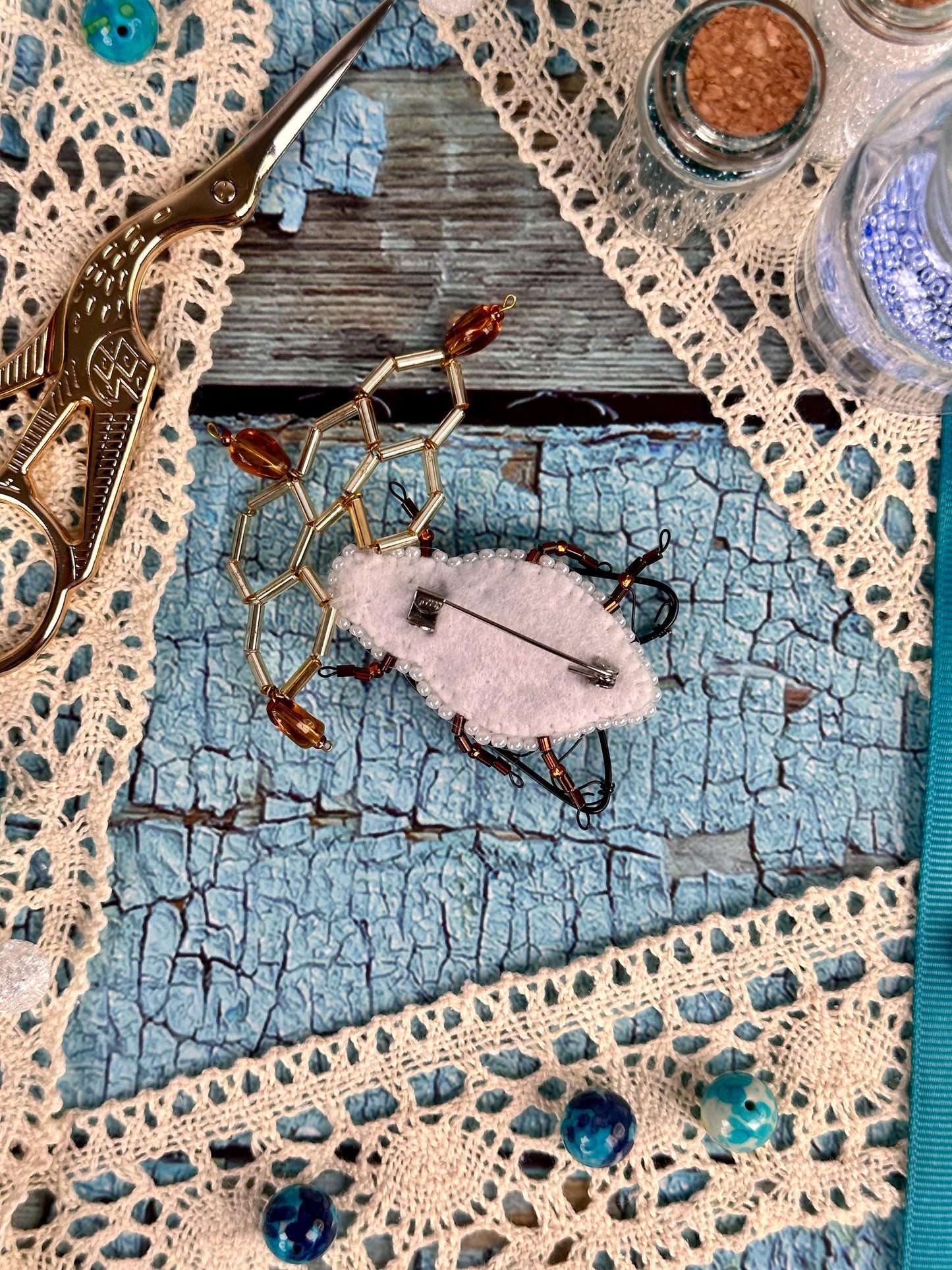 a pair of scissors sitting on top of a piece of cloth