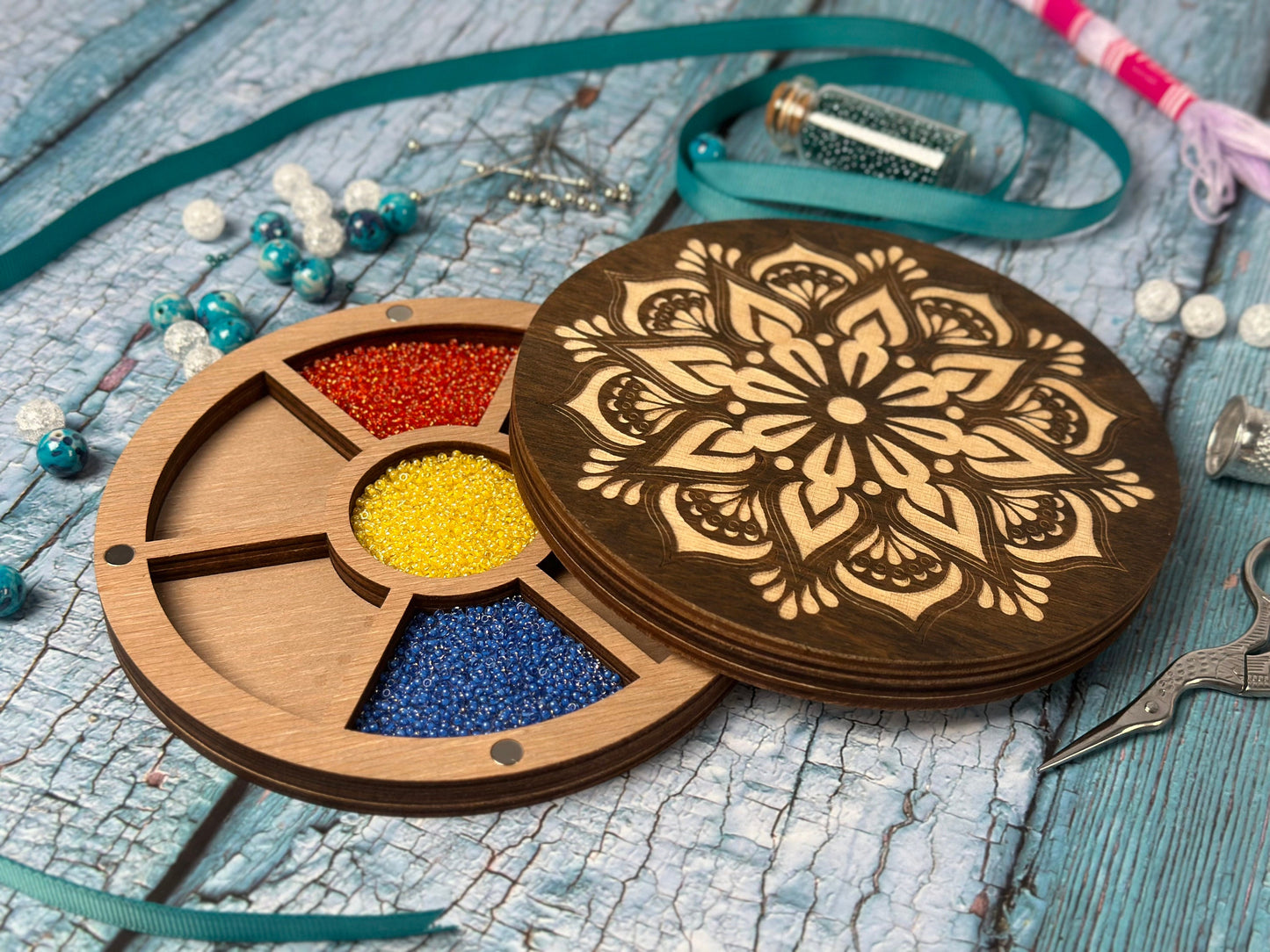 a wooden box filled with different colored beads
