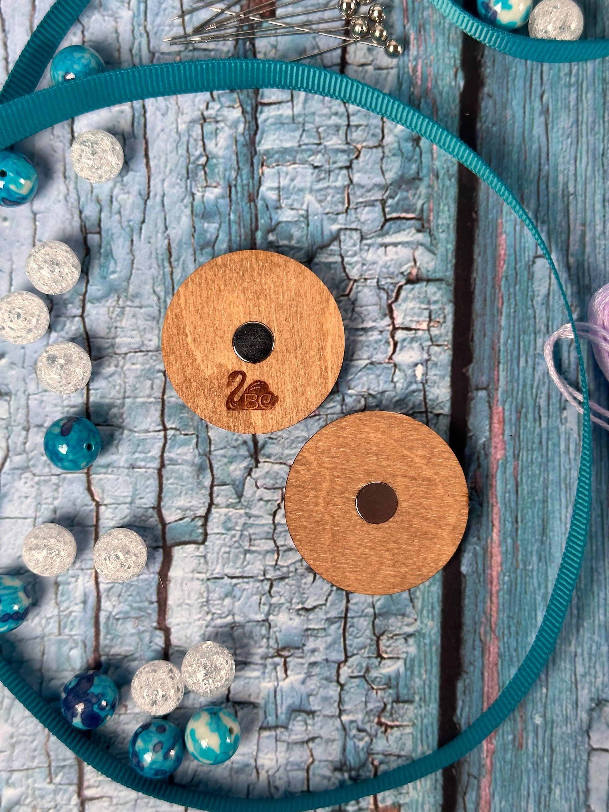 a pair of wooden buttons sitting on top of a wooden table