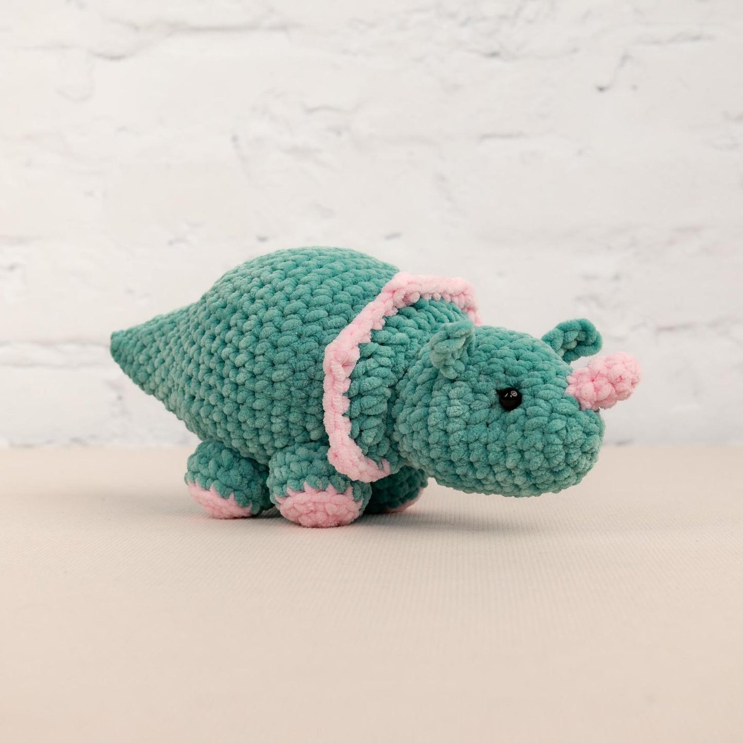 a crocheted hippo is sitting on a table