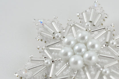 a close up of a snowflake made of pearls