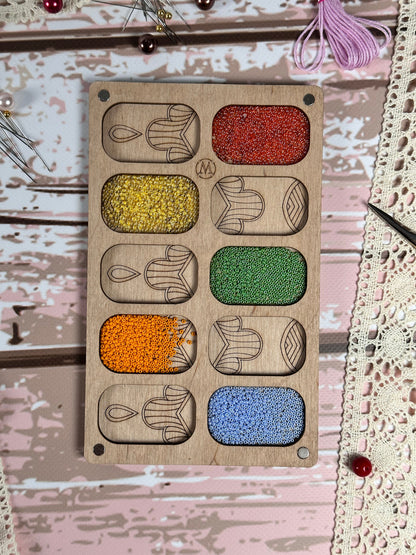 a picture of a wooden board with different colors of beads