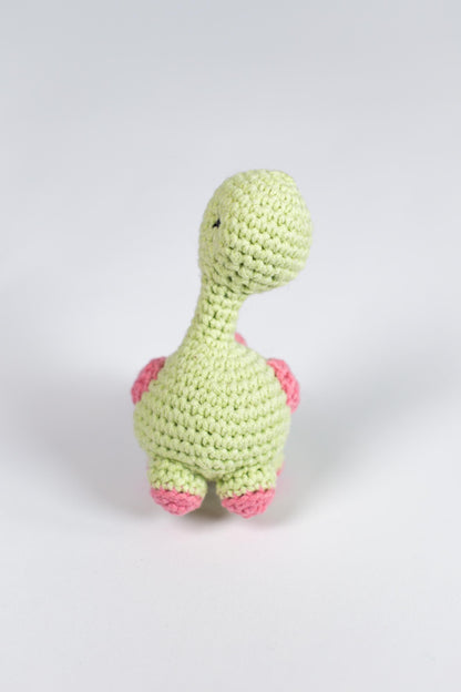 a crocheted toy of a green dinosaur
