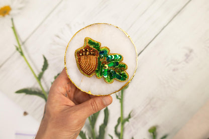 a person holding a brooch in their hand