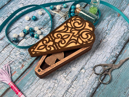 a pair of scissors and some beads on a table