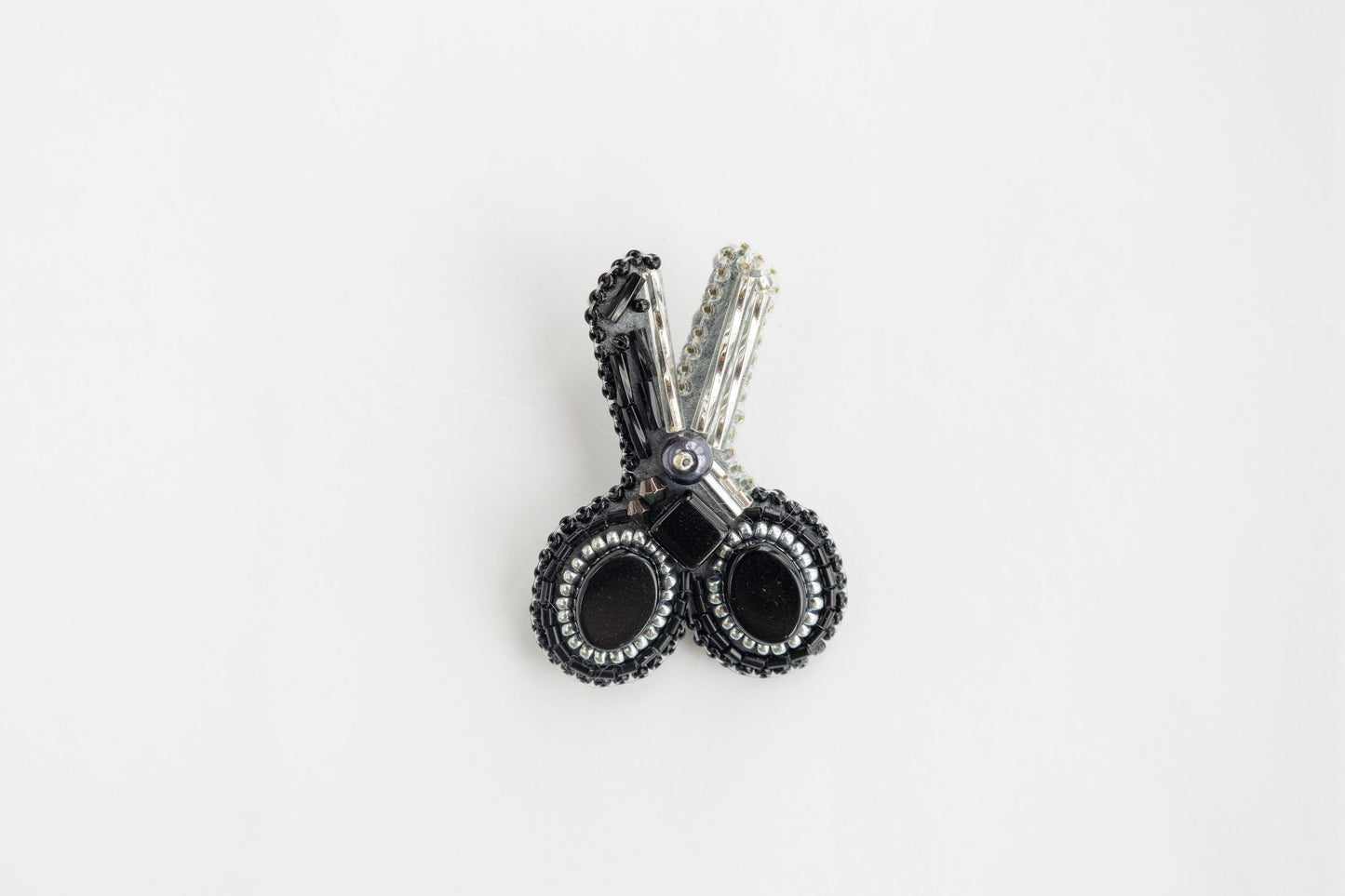 a pair of black and white earrings on a white background