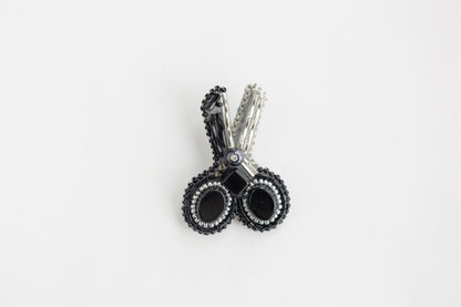 a pair of black and white earrings on a white background