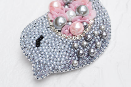 a close up of a purse with pearls on it