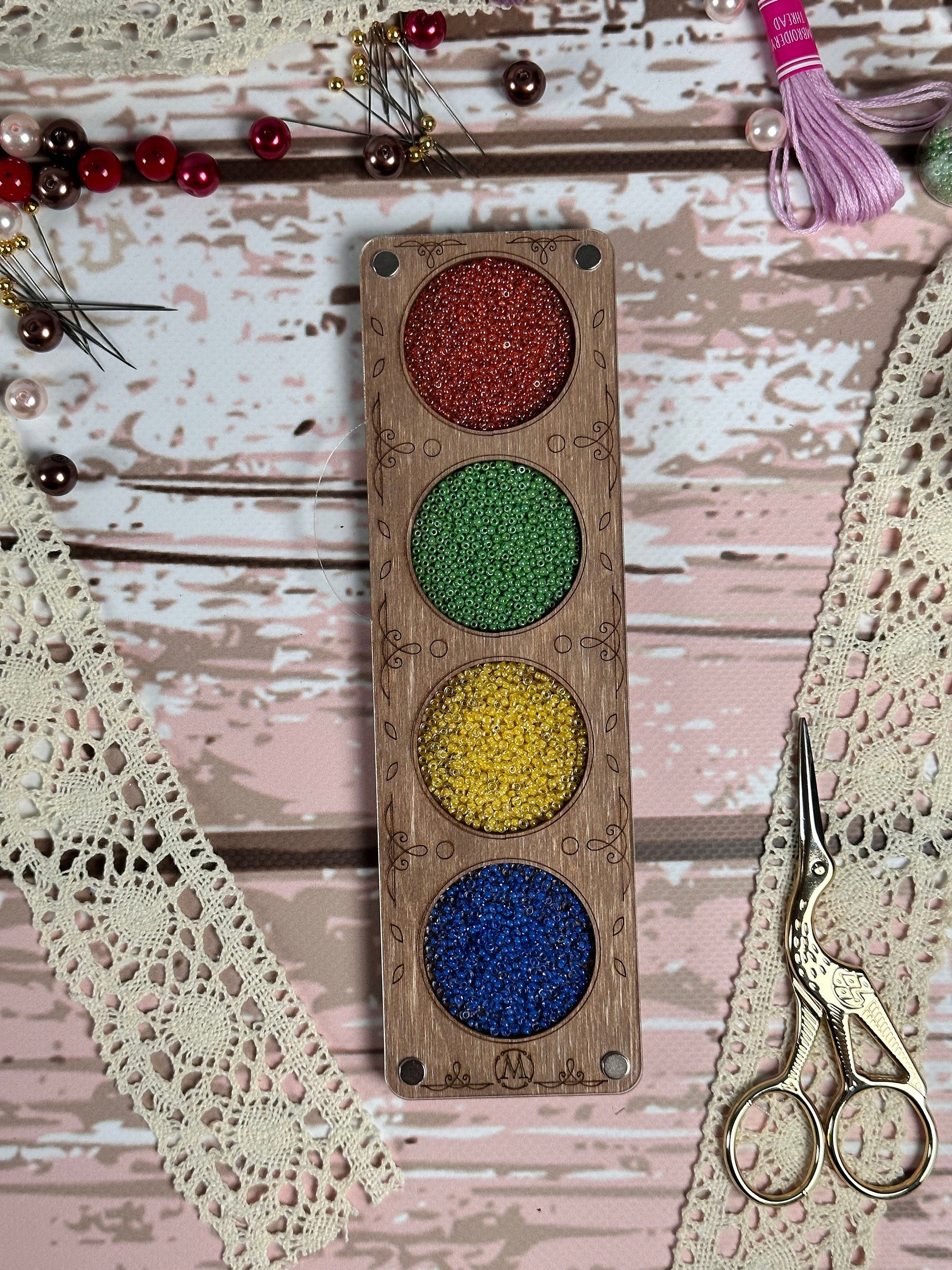a pair of scissors and some beads on a table