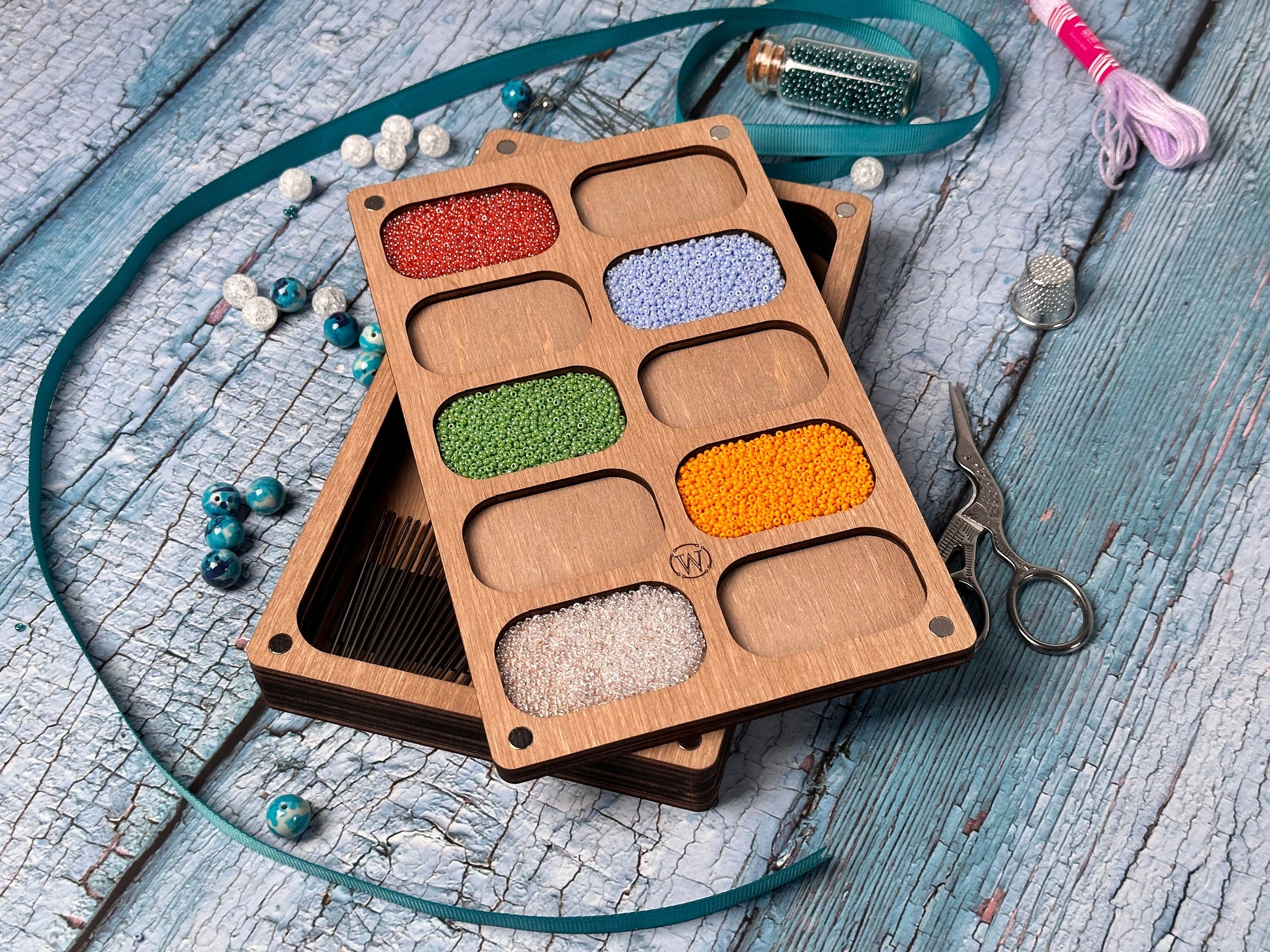 a wooden box filled with different colored beads