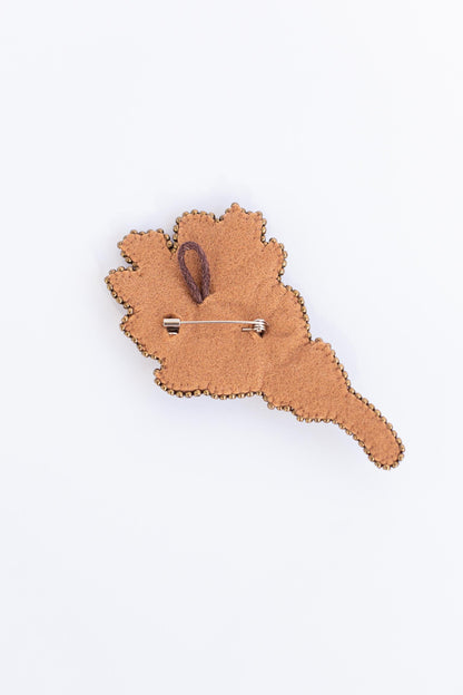 a piece of wood with a clock in the shape of a map