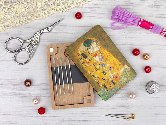 a pair of scissors, a pair of knitting needles, a pair of knitting needles