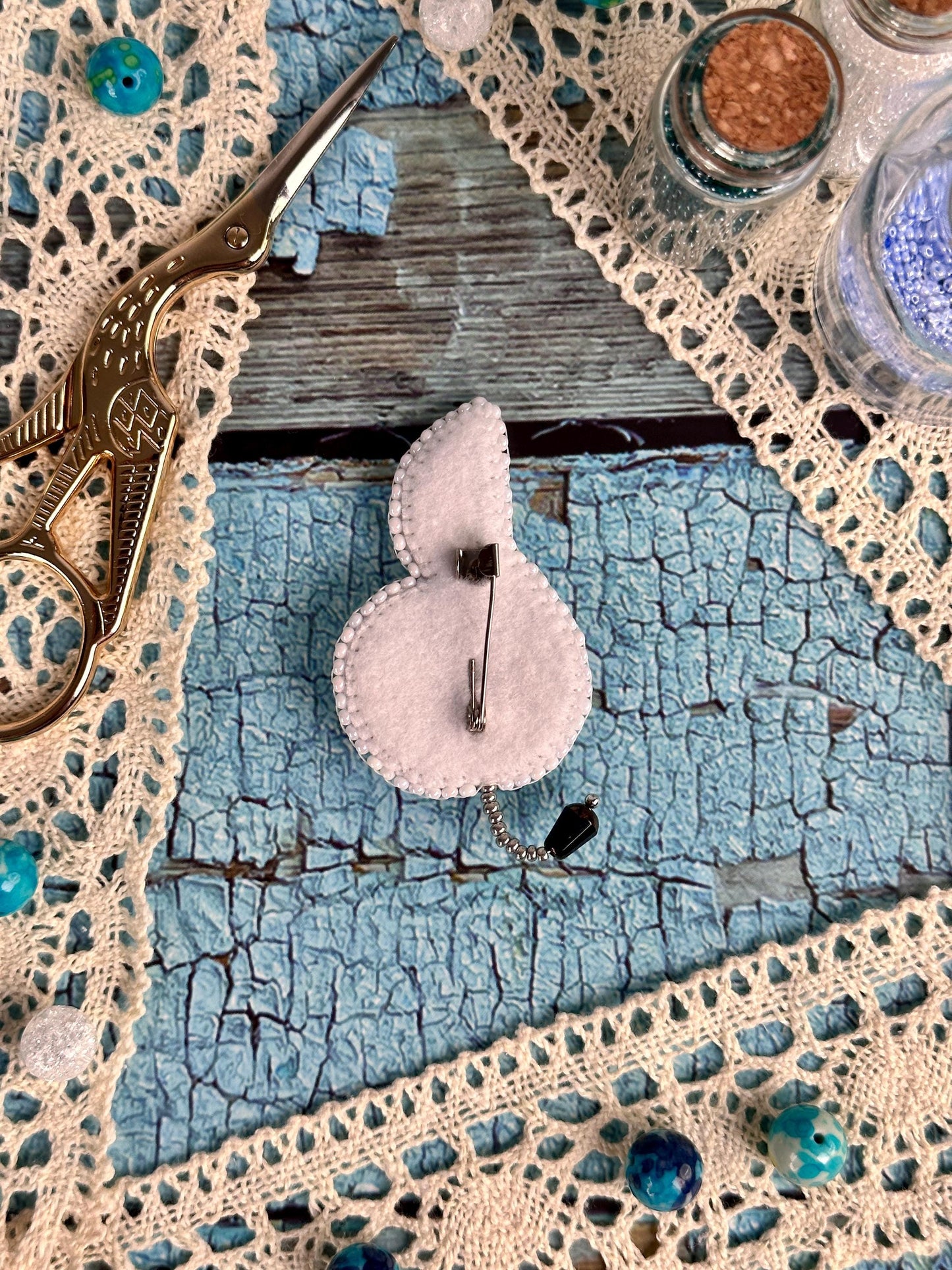 a pair of scissors sitting on top of a piece of cloth