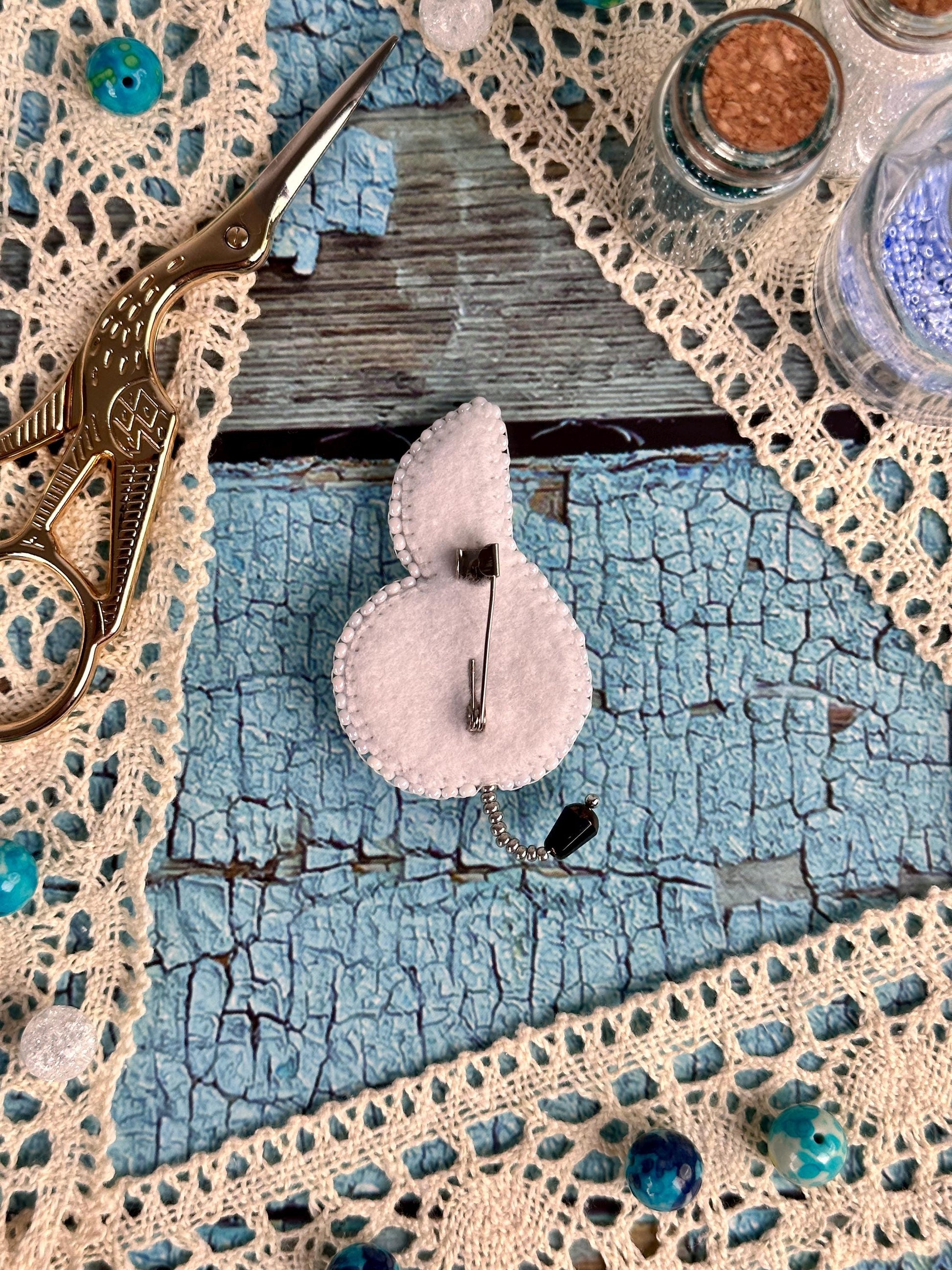 a pair of scissors sitting on top of a piece of cloth