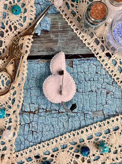 a pair of scissors sitting on top of a piece of cloth