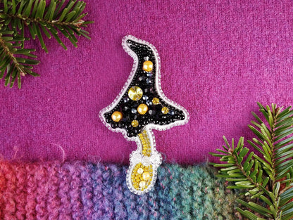 a knitted christmas tree ornament on a purple background