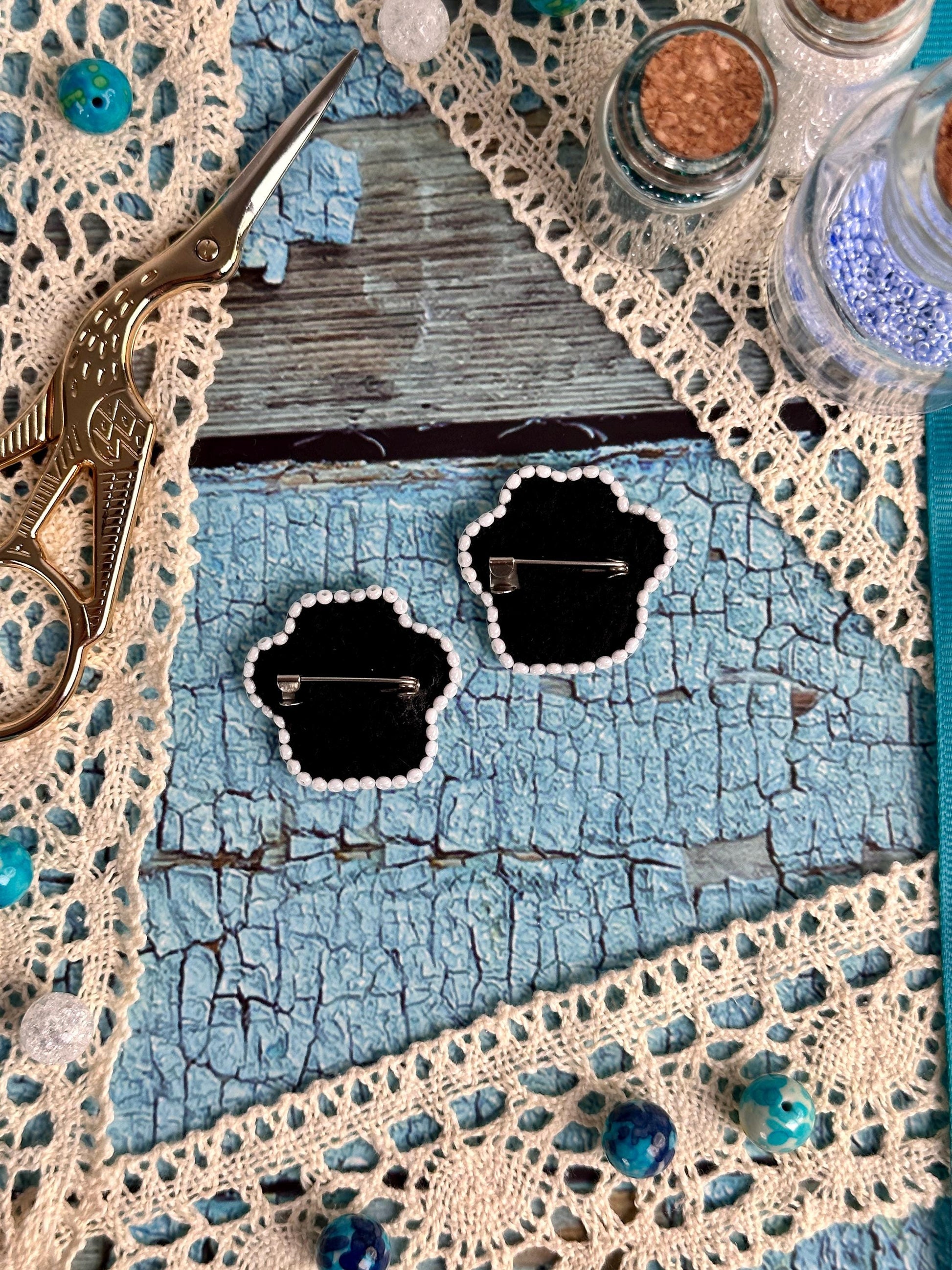 a pair of scissors sitting on top of a doily