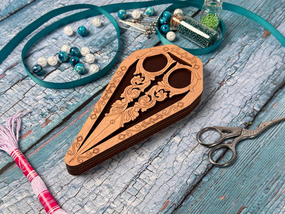 a pair of scissors and a wooden case on a table