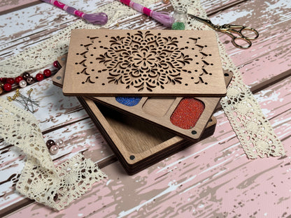 a wooden box with a cutout of a flower on top of it
