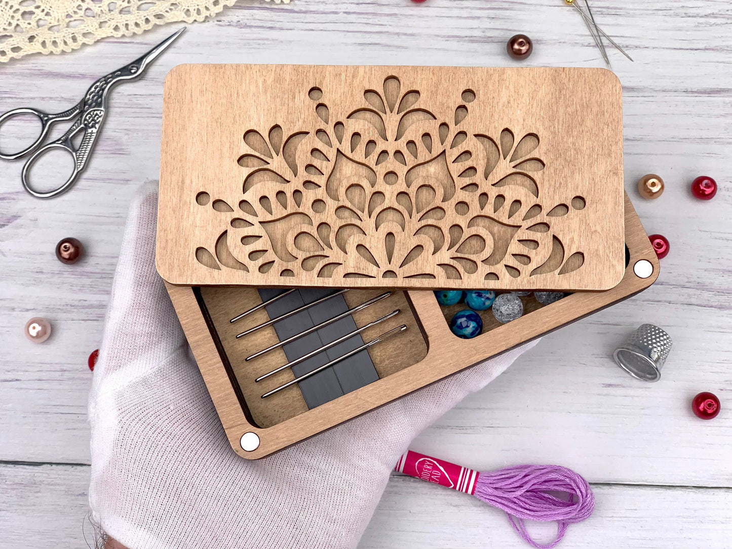 a pair of scissors and a box of knitting needles