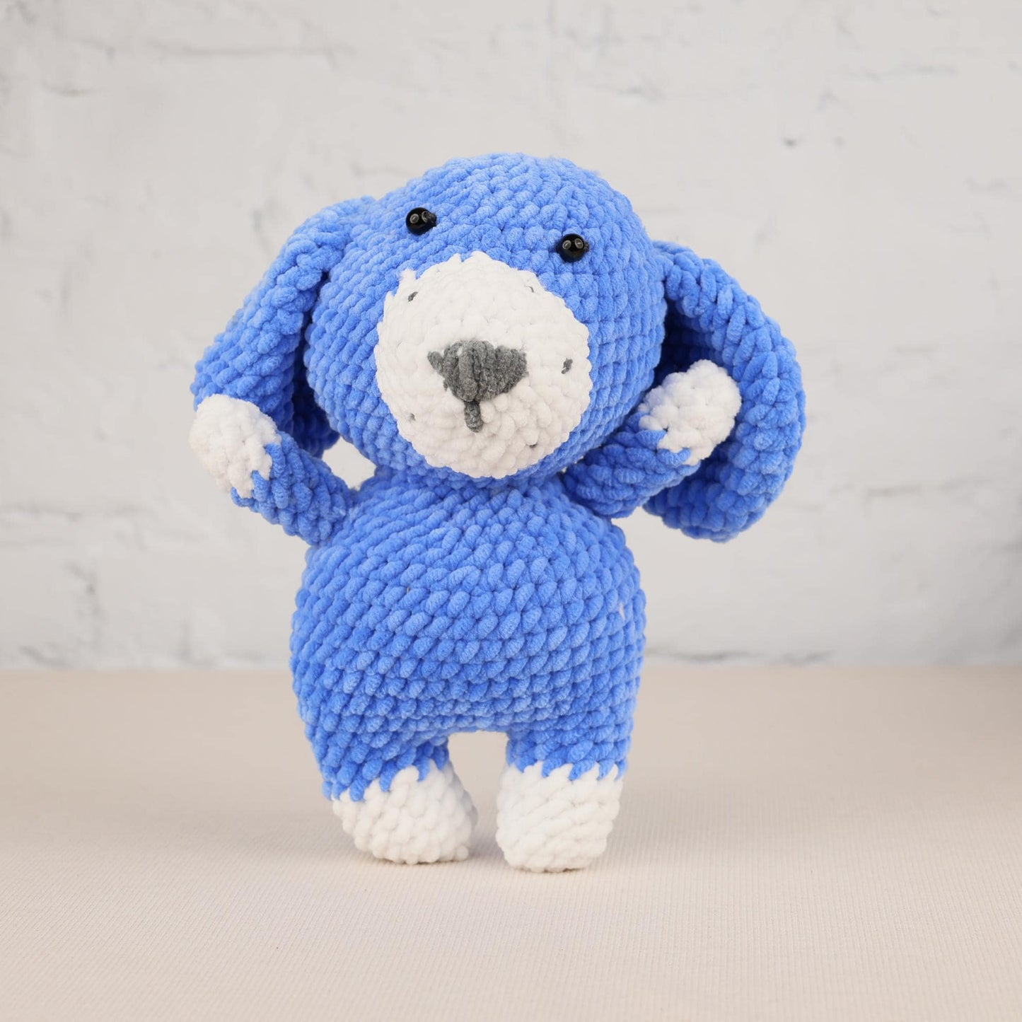a blue and white stuffed animal on a table
