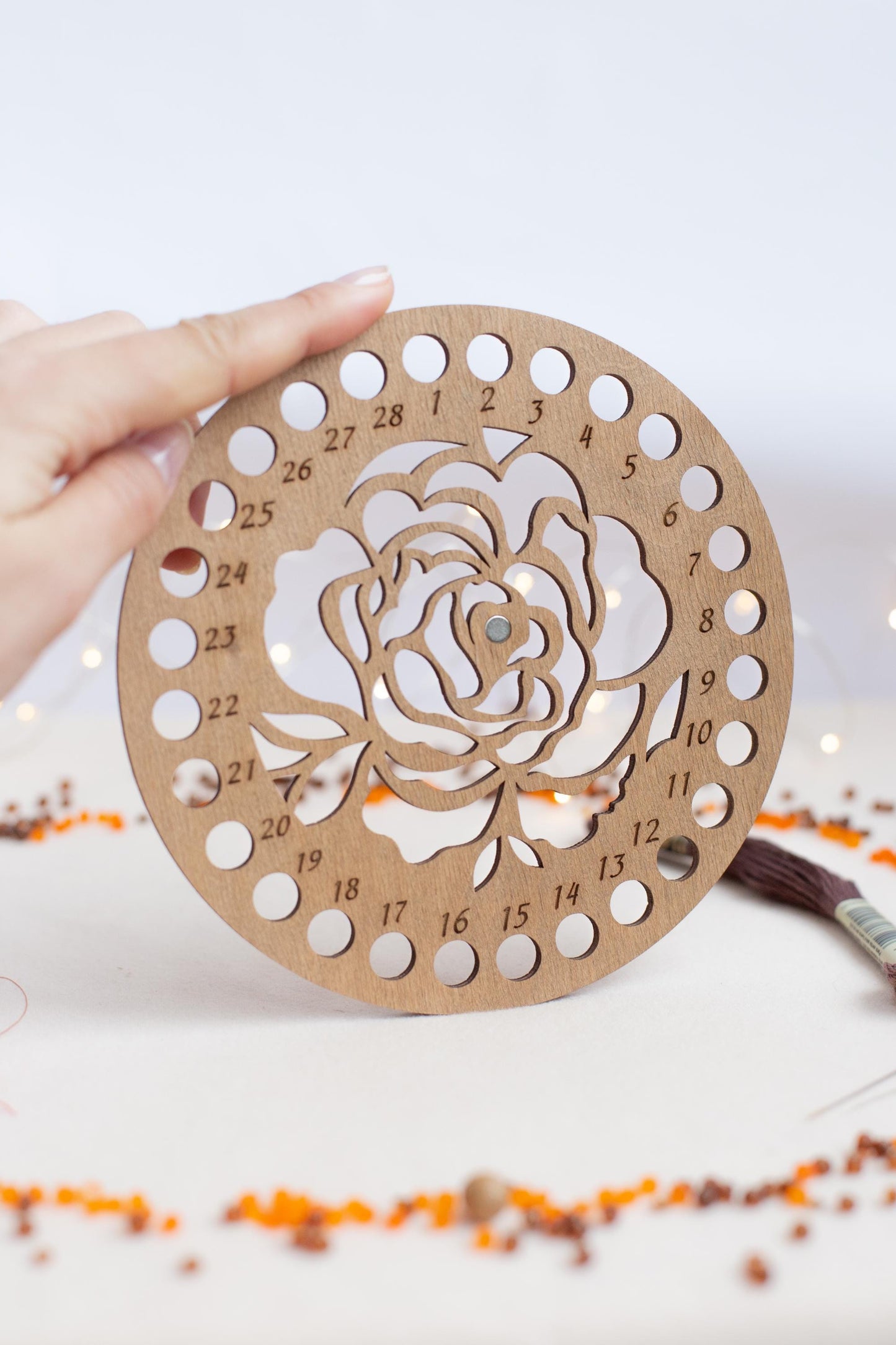 a person holding a wooden cutout of a rose