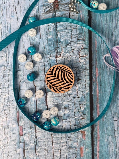 a necklace with a wooden design on it
