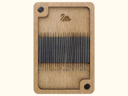 a close up of a piece of wood with needles