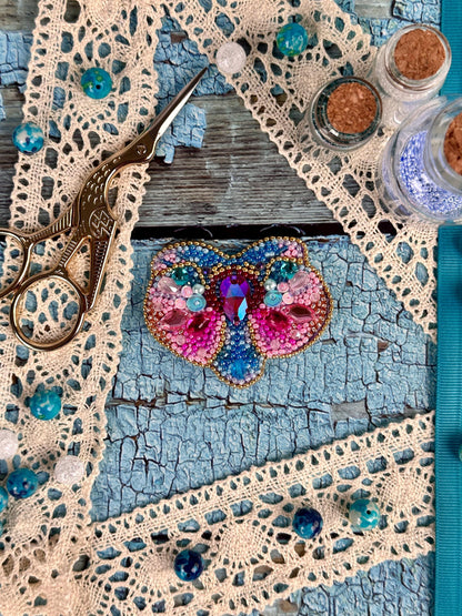 a pair of scissors sitting on top of a doily