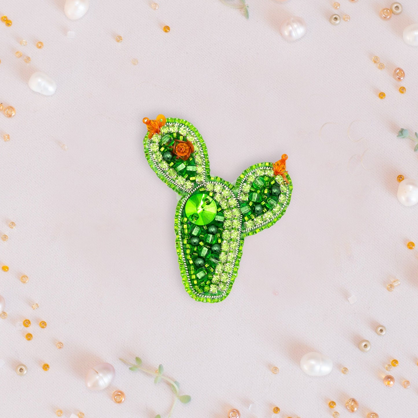 a green brooch with a cactus design on it