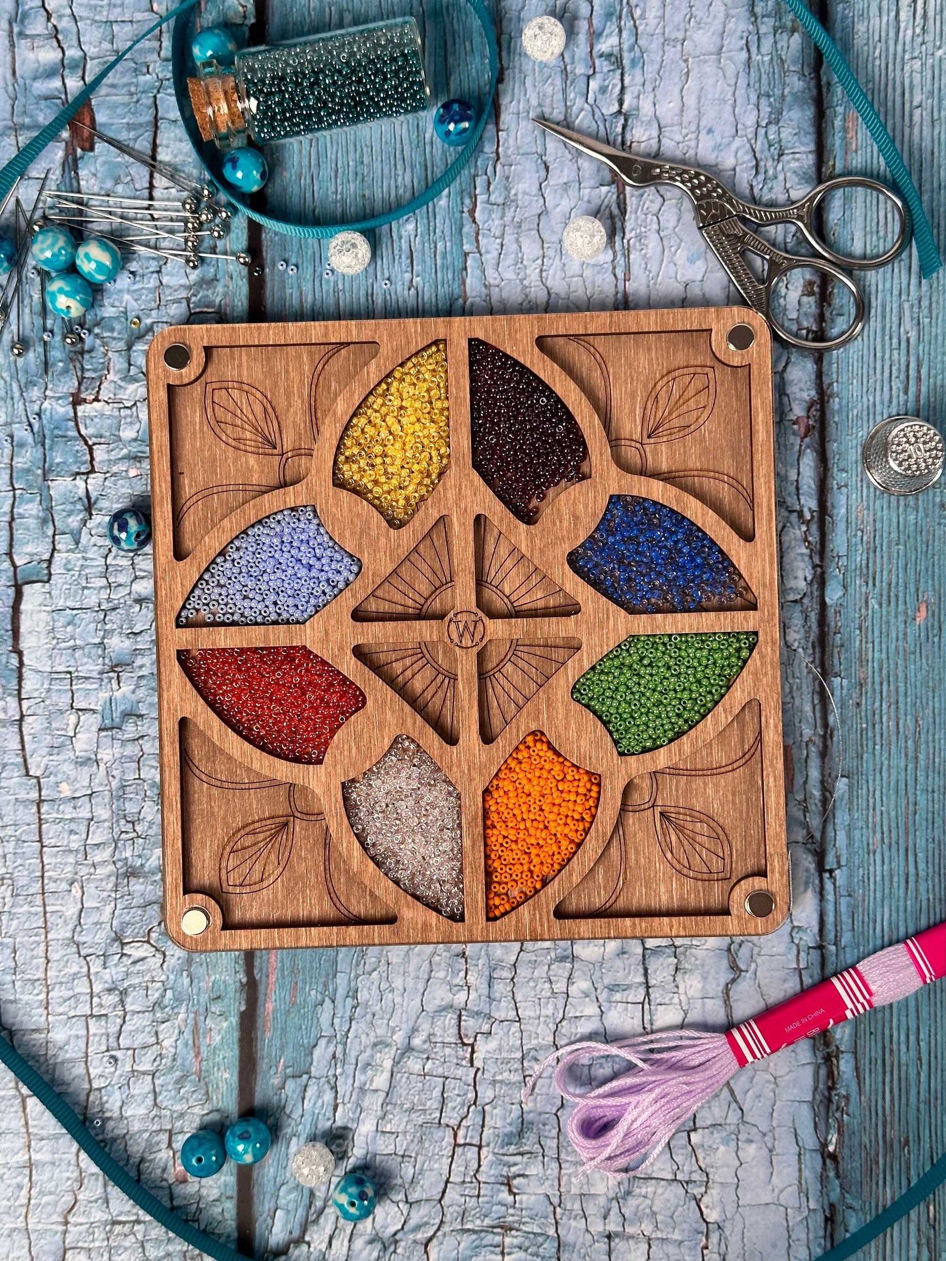 a wooden board with a bunch of beads in it