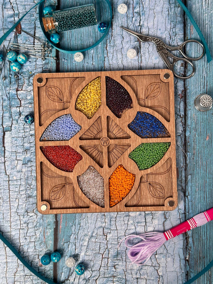 a wooden board with a bunch of beads in it