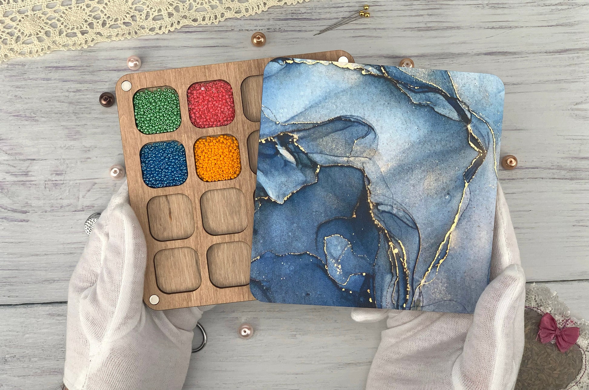 a person holding a paint palette in their hands