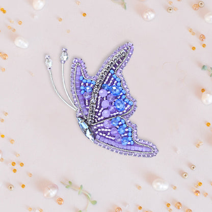 a picture of a butterfly in a frame surrounded by beads