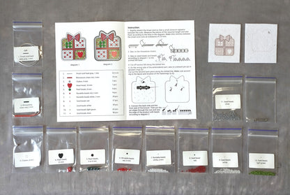 various craft supplies, including clear plastic bags, zippered bags, and instructions for a project. The supplies appear to be related to a sewing or embroidery project, with a focus on beads and other decorative elements.
